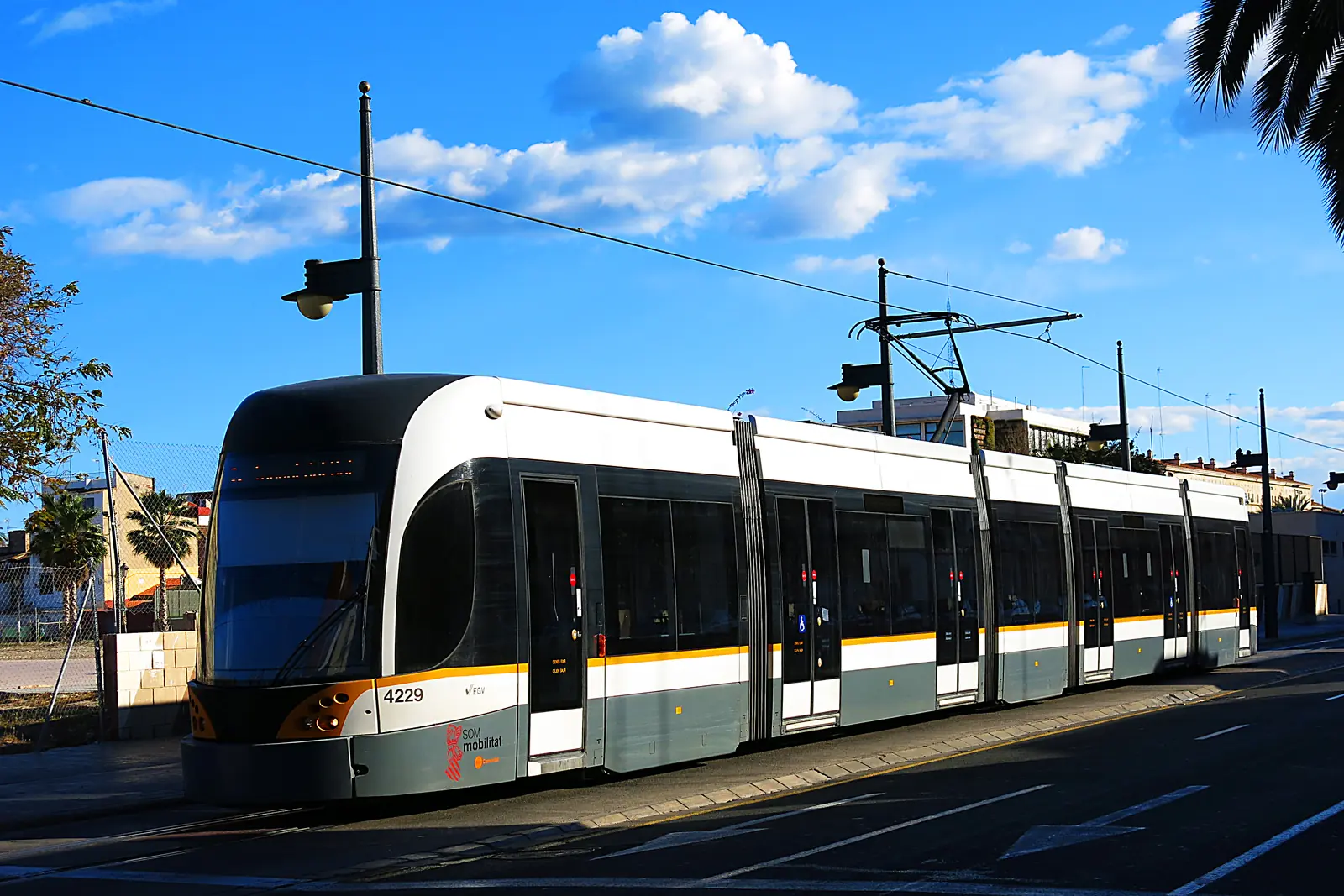 A Valencia tram on Carrer del Doctor Lluch in the Cabanyal under a blue sky